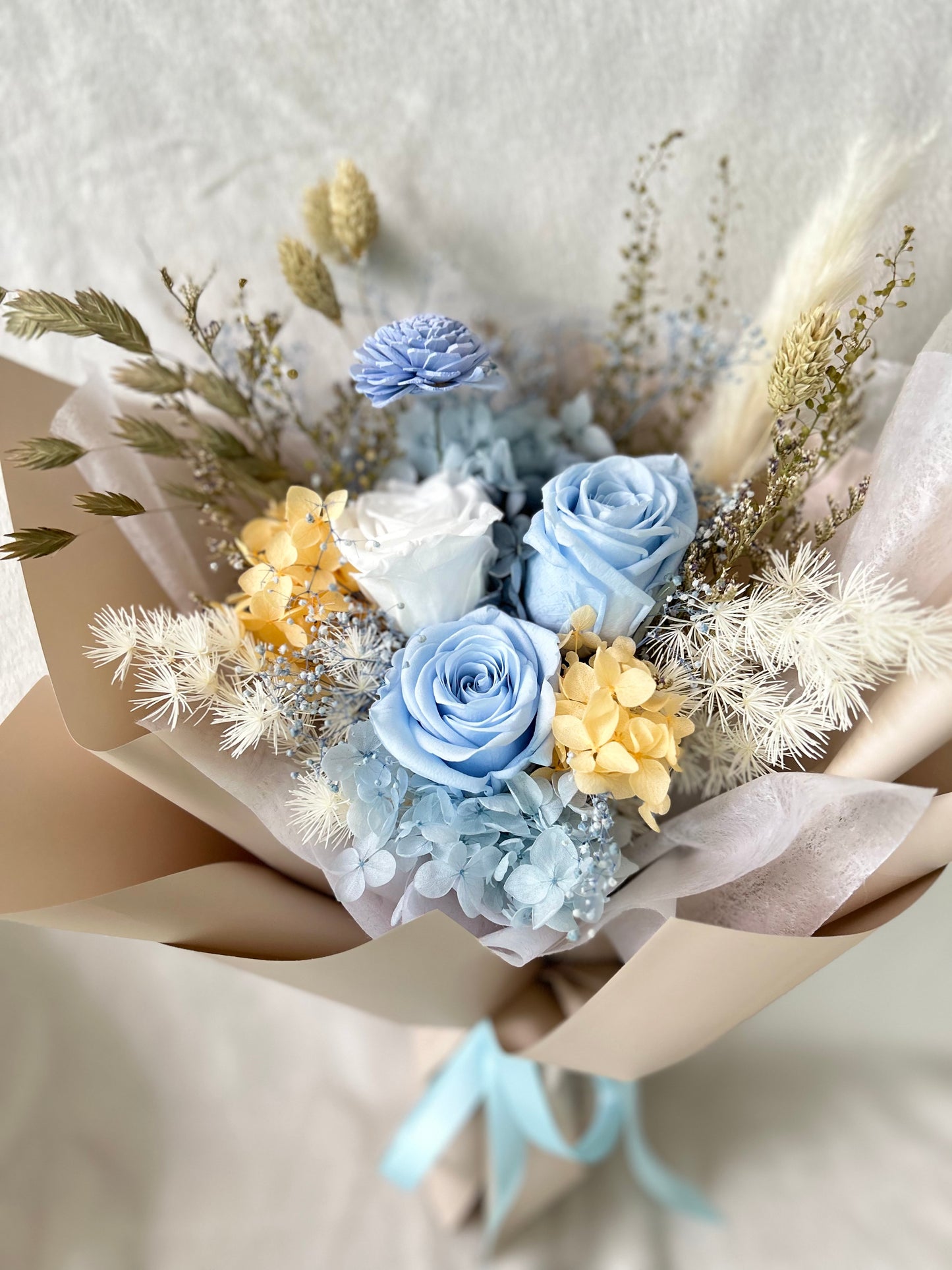 Pastel blue rose bouquet with yellow hydrangea