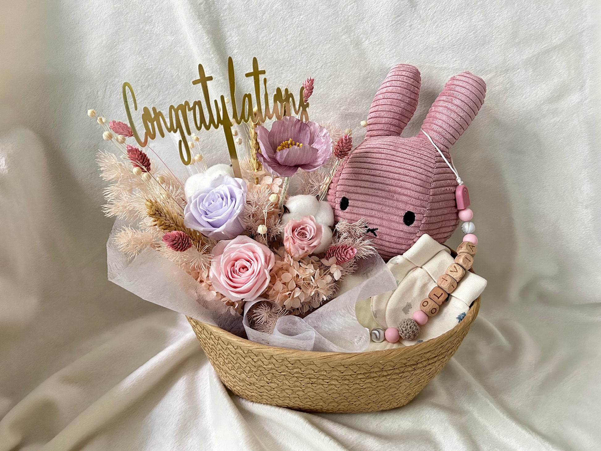 Pink baby gift basket with flowers and bunny