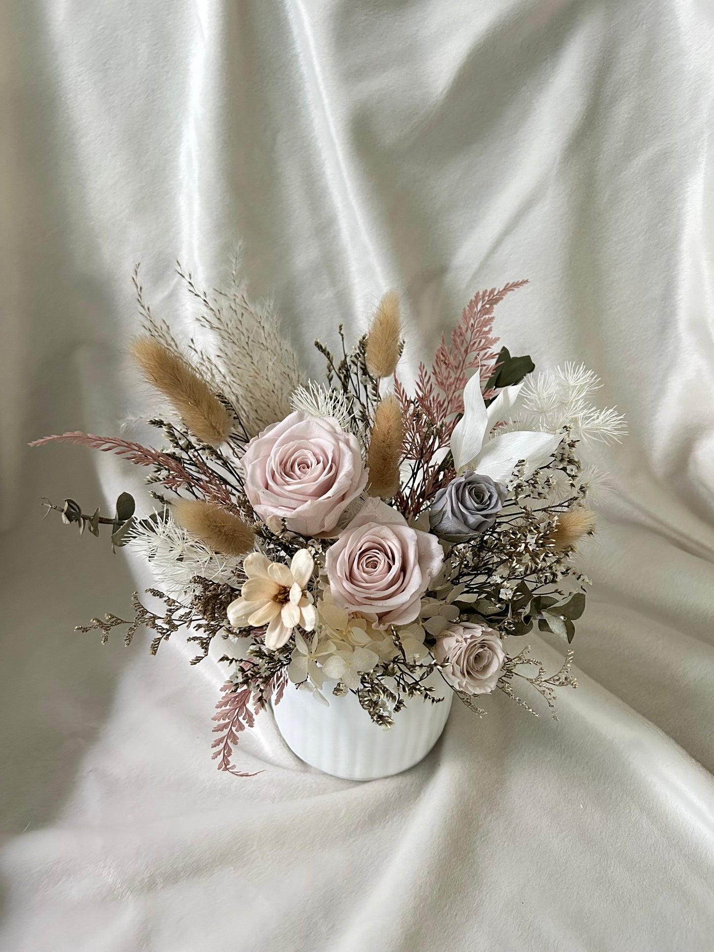 Soft pastel pink roses in a vase