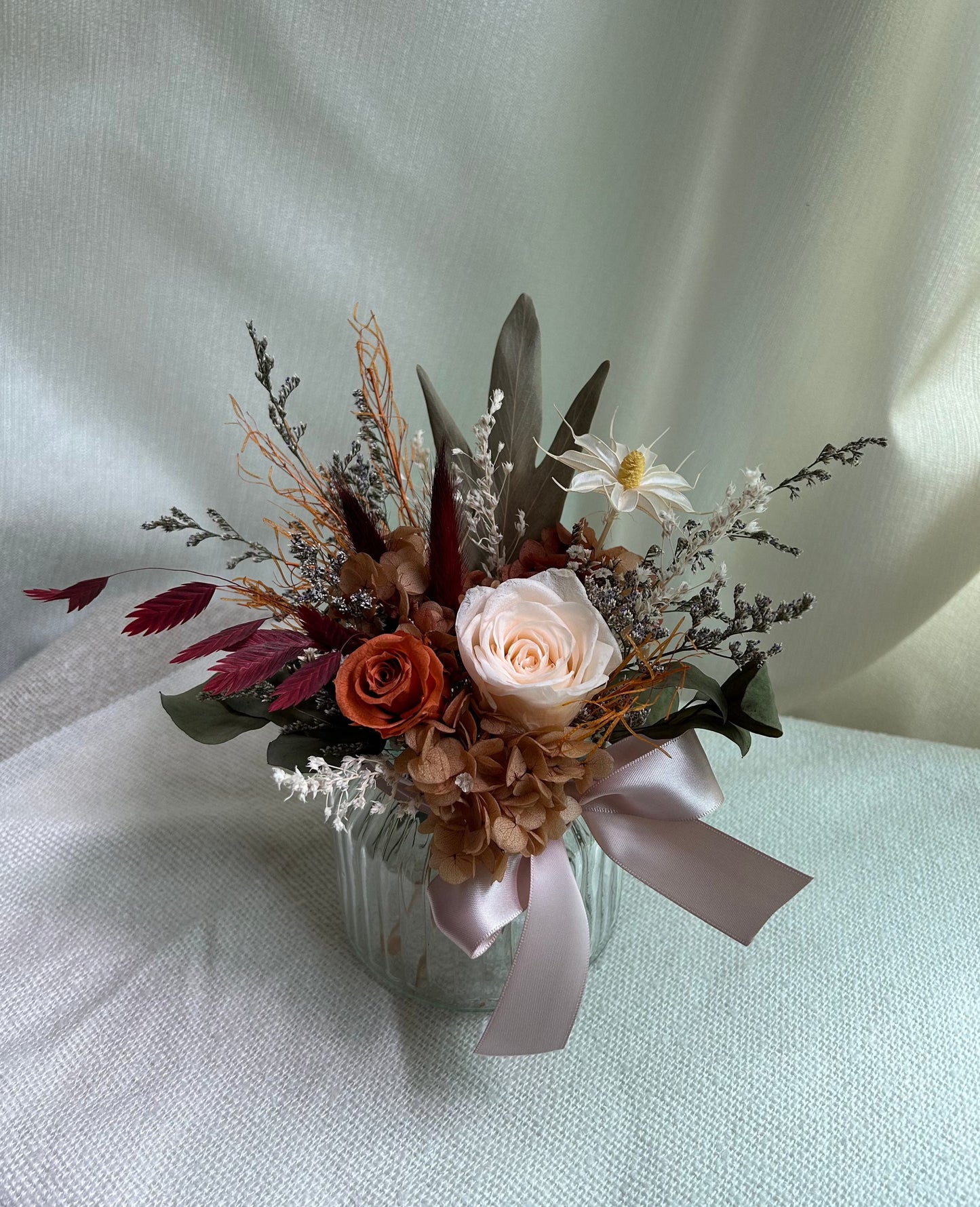 Preserved orange Roses flower arrangement in vase front view