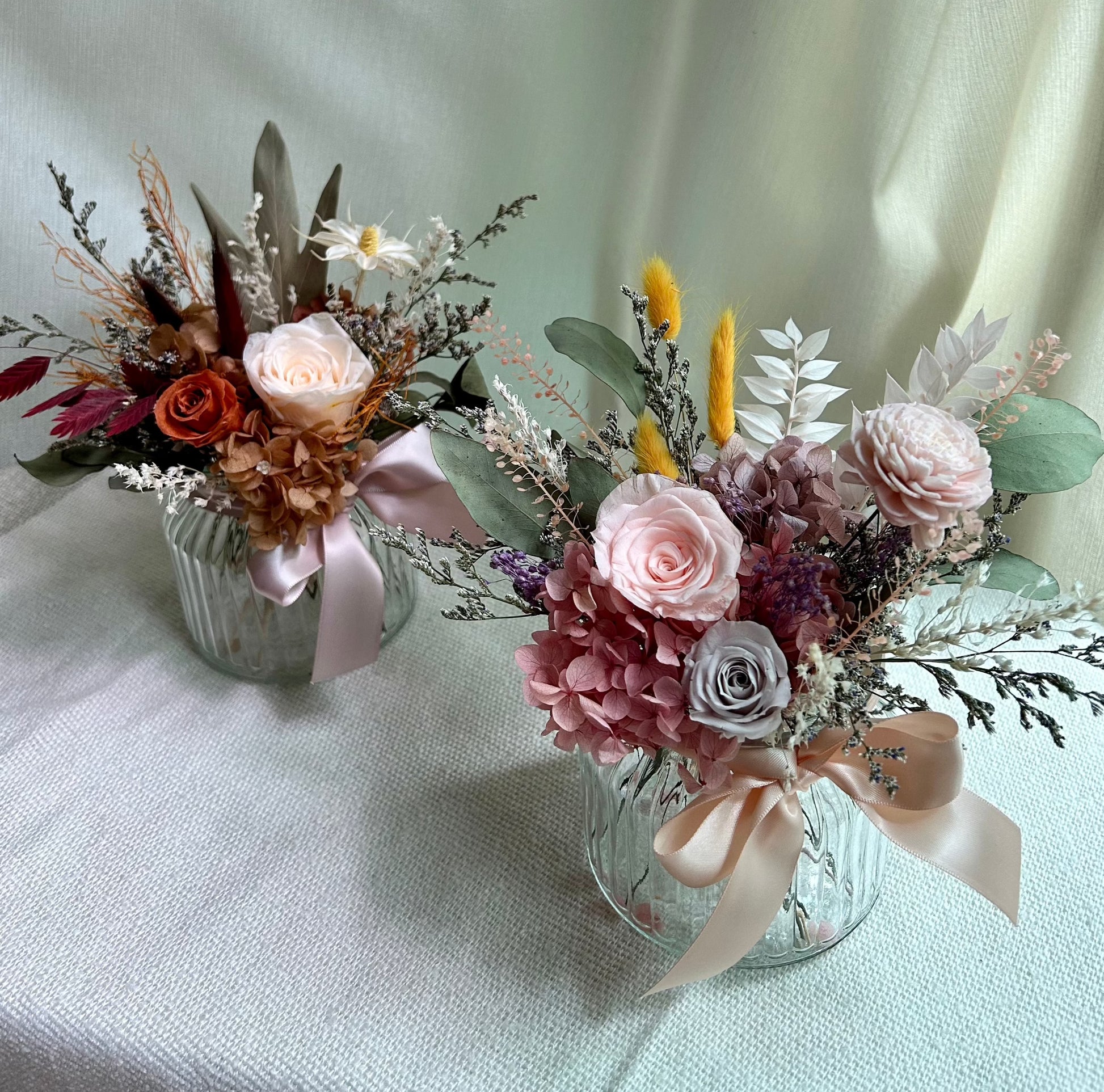 Preserved roses vase arrangements in pink and orange colours